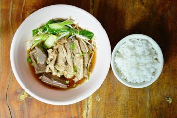 boiled duck meat and blood in brown Chinese herb soup on bowl eat couple with rice