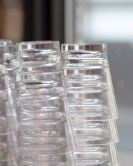 transparent glasses stored with background natural light ideal for bar sign or restaurant sign 