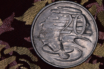 Closeup of an Australian 20 cent coin on a dark background.