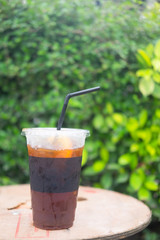 Iced black coffee on wood table