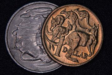 Closeup of an Australian 1 dollar and 20 cent coin on a dark background.