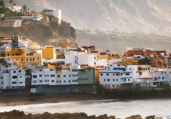 View of colorful houses of Puerto de la cruz, Jardin beach with sunlight at sunset, Tenerife, Canary islands, Spain