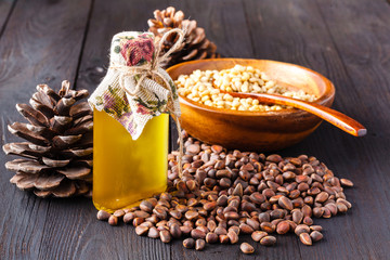 heap of pine nut and oil on wooden table