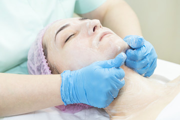Massage and facial peels at the salon using cosmetics 