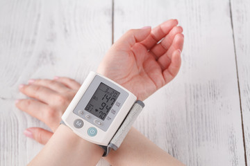 Senior woman measuring blood pressure. Health care background