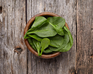 Spinach on wooden background