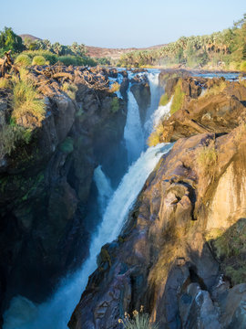 View over beautiful scenic Epupa Falls on Kunene River between Angola and Namibia in evening light, Southern Africa