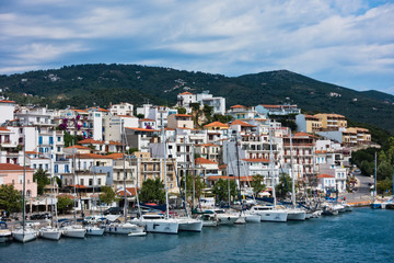 Cityscape of Skiathos town and harbor from the sea at morning in Greece