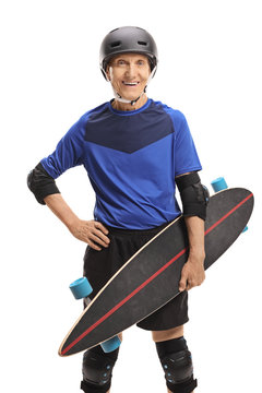 Senior with a longboard and protective equipment