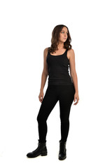 full length portrait of brunette girl wearing black singlet, jeans jeans and boots. standing pose, isolated on white studio background.