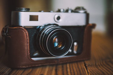 Fototapeta na wymiar Vintage camera on wooden background