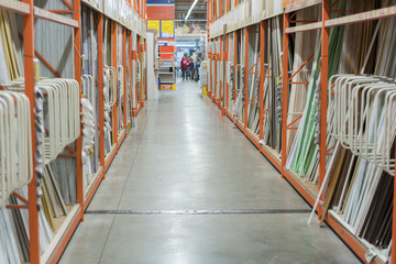 interior of hardware retailer with aisles, shelves, racks of building material insulation floor to ceiling.