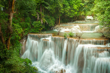Fototapeta na wymiar Beautiful and Breathtaking green waterfall at the tropical rain forest, Erawan's waterfall, Located Kanchanaburi Province, Thailand