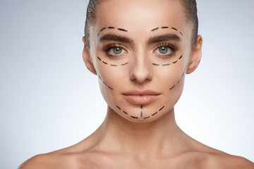 Beautiful woman with puncture lines on face