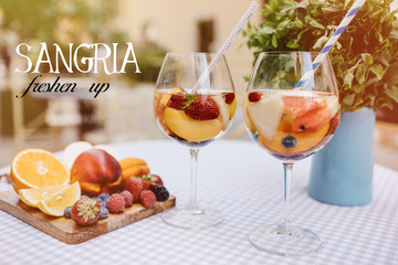 Top view of summer dinks, fruit cocktails on white wood table with berries, mint leaves