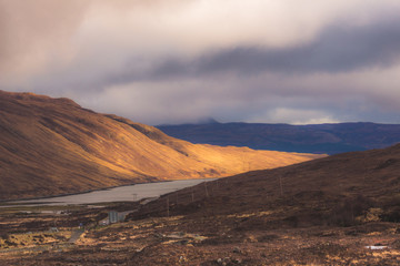 Naklejka premium Isle of Skye, dramatic landscape with sunbeam shinning on a mountainside.