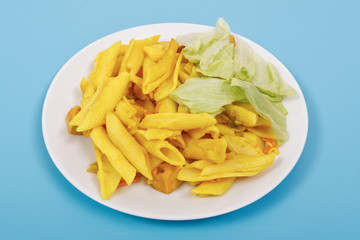 Baked pasta with curry on a blue