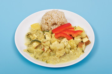 Cauliflower mixture with curry and rice on a blue
