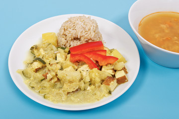 Cauliflower mixture with curry and rice on a blue