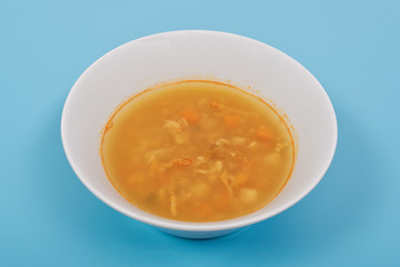 Groat soup with vegetables on a blue