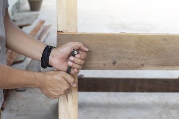 People carpenter manual use Wrench for entangle of Screw thread to structure of wooden.