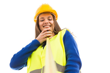 Young female engineer holding measuring tape.