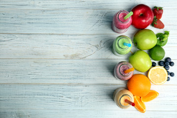 Flat lay composition with healthy detox smoothies and ingredients on wooden background