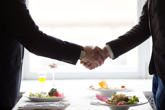 businessman shaking hands before business lunch. Business lunch concept.