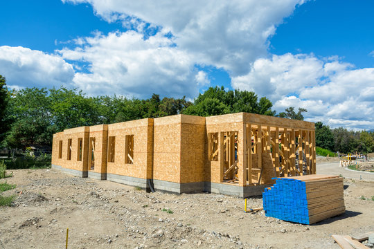 Wooden frame of new building with engineered lumber materials on site prepared for construction. Tow by four lumber wood. 2by4