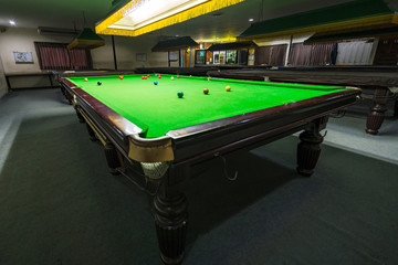 Snooker table with Multicolor snooker balls on green in the club