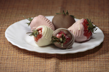 Strawberries covered in milk chocolate, delicious dessert, concept of business break.