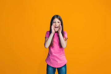 Isolated on pink young casual teen girl shouting at studio