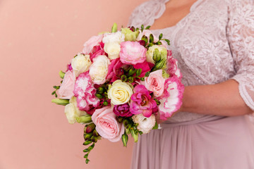 Beautiful wedding bouquet of flowers in bride's hands