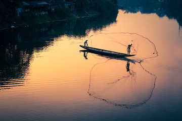 Vietnamese fishermen in famous Perfume River in Hue City, Vietnam