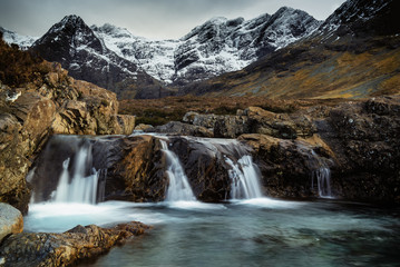 Fototapeta na wymiar Snowy Mountainous landscape with Waterfalls at Fairy Pools, Brittle River, Isle of Skye, Scot