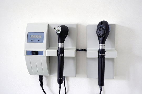 Medical Equipment with otoscope ear scope and ophthalmoscope eye scope hanging on a doctor's office wall