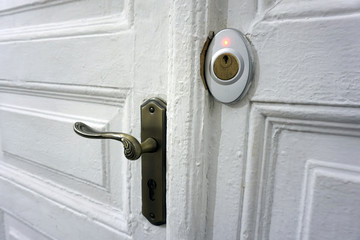 old white wooden door with a handle and a modern lock