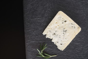 blue cheeseon a stone background, rosemary
