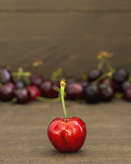 Ripe fresh cherries on wooden background.
