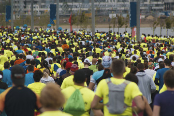Gray day, city marathon, a lot of running people in sports cloth