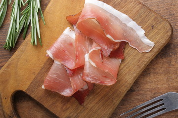 prosciutto, jamon on a wooden background