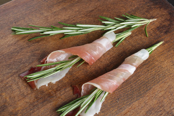prosciutto, jamon on a wooden background