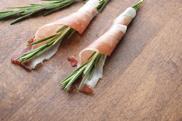 prosciutto, jamon on a wooden background