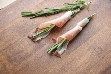 prosciutto, jamon on a wooden background