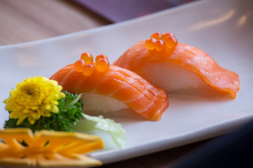 Salmon sushi nigiri in White Plate on a wooden table.Japanese Food.