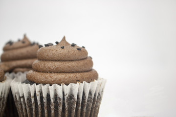 A chocolate cupcake on an isolated white background with room for text