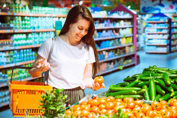 woman buying vegetables in grocery store. shopping concept