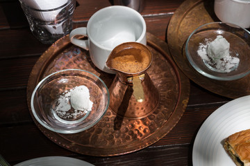 Greek coffee copper pot on a tray.