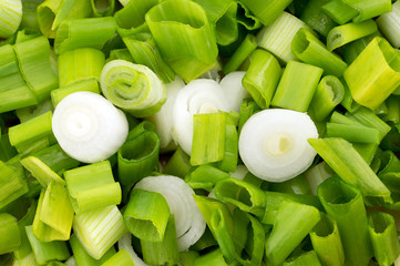 chopped green spring onions background.