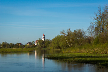 Obraz premium Church in Suraz over the Narew river, Podlaskie, Poland